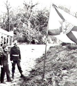 Raising the North Novas Battle Flag on German soil are (l to r): Sgt. Kelly Grant and R.S.M. J.L. MacNeil